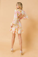 Load image into Gallery viewer, A printed woven mini dress featuring V-neckline with fully lined, ruffled edge, long sleeve with ruffled cuff, waist yoke, ruffled hemline, triangle back cut out with button and zipper closure.  
